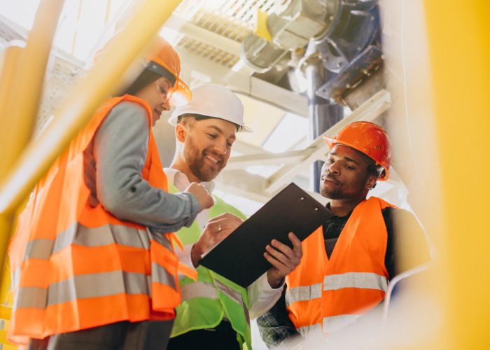 three-people-discussing-plan-factory